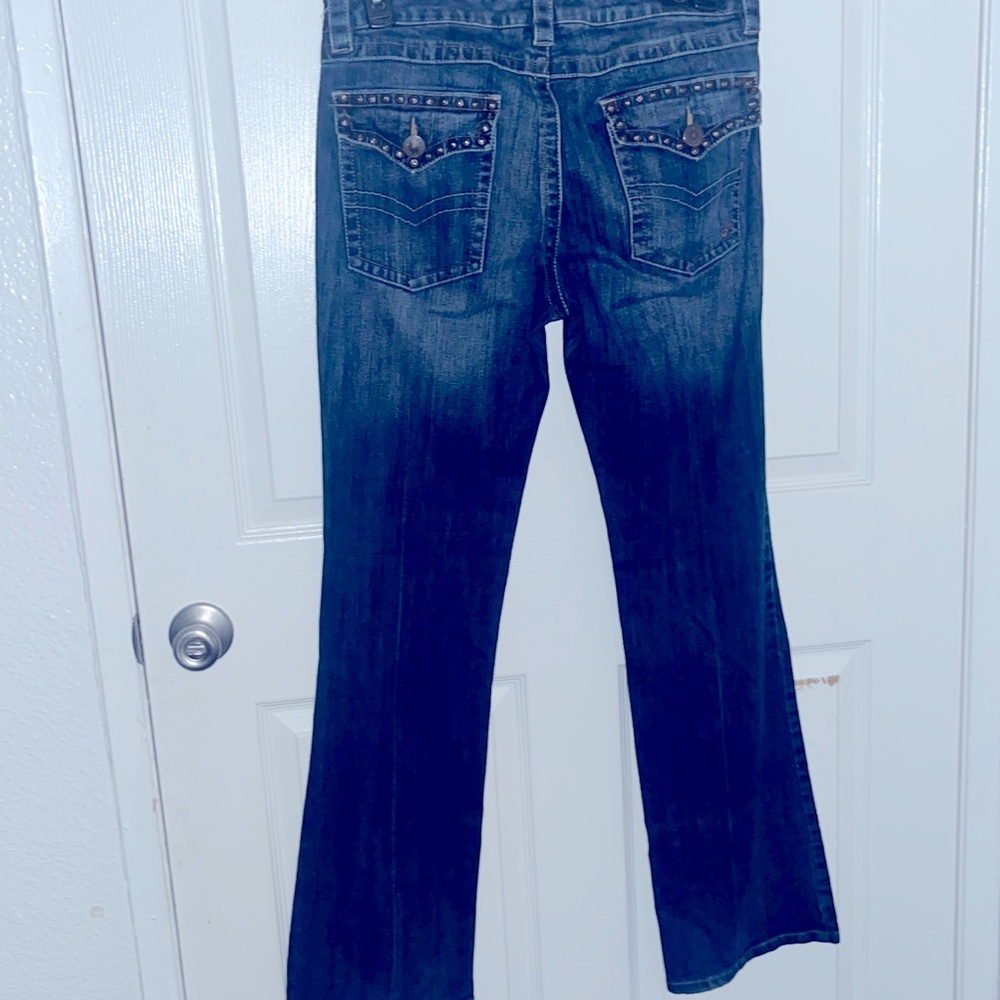boot cut woman’s jeans . with studded pockets,
